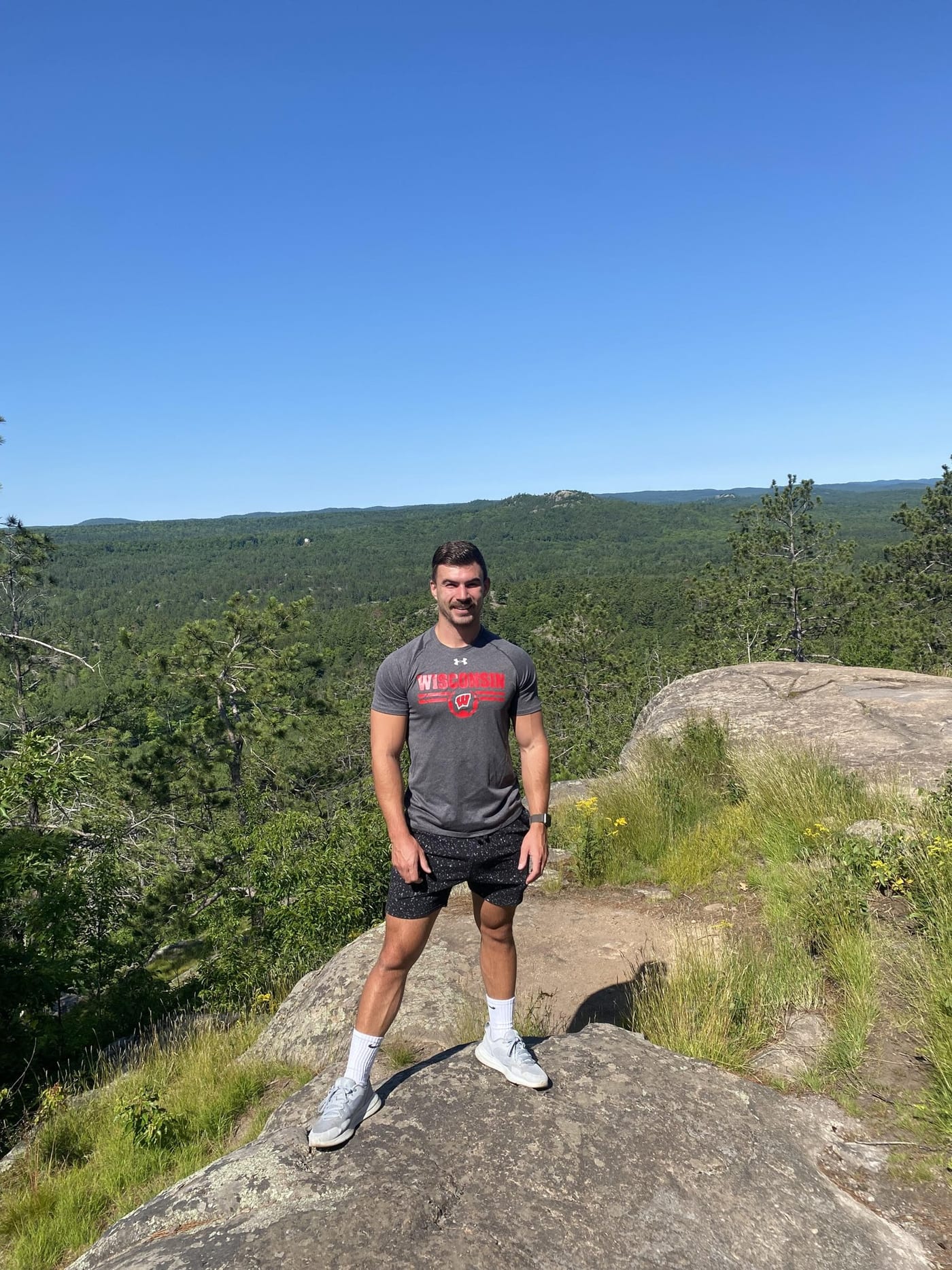 Nate Bladecki hiking at an overlook, outdoors.