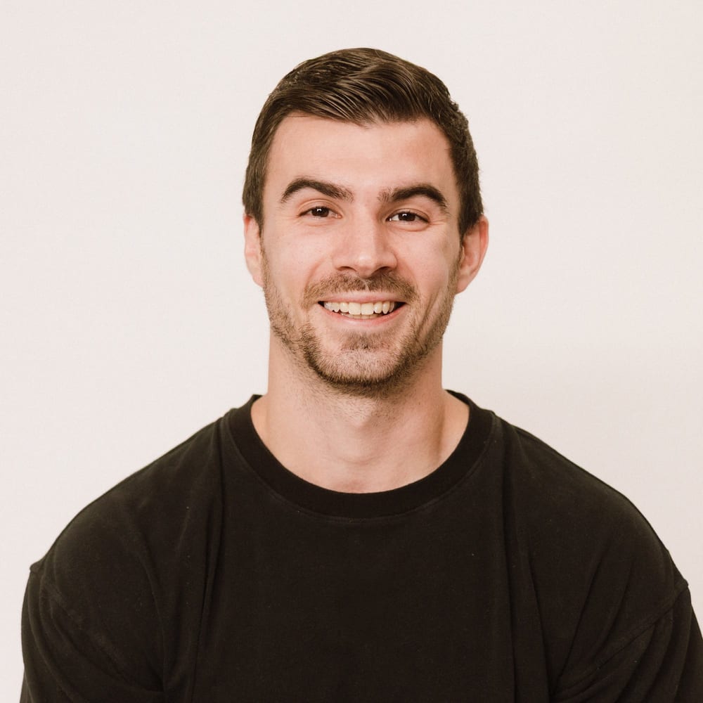 Portrait of Nate Bladecki, registered dietitian, in a black t-shirt.